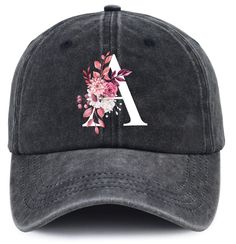 a black hat with pink flowers on the front and white letters at the back, embroidered onto it