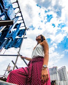 a woman standing on top of a metal structure