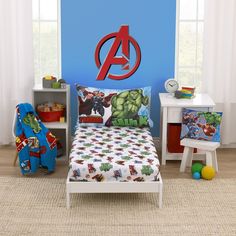 a child's bedroom with the avengers logo on the wall and toys in the corner