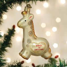 a baby's first christmas ornament hanging from a tree