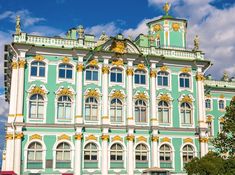 a large building with many windows and gold trimmings on the top of it