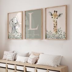 three framed pictures hang on the wall above a bench with storage bins underneath them