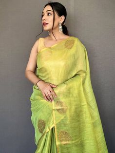 Nothing will be comparable when your beauty will be combined with this stunning tissue silk material light green saree beautified with jacquard zari weaving with motifs all over the borde work and having rich pallu. This awesome woven silk light green saree comes with a golden color plain blouse in silk fabric. This stunning traditional woven silk saree is 5.50 meters long and comes with fully unstitched 1.00 meters blouse material. Update your clothing style as per trend with this beautiful sil Pre-draped Saree For Puja Festivals, Festive Pista Green Chanderi Pre-draped Saree, Festive Pista Green Handloom Pre-draped Saree, Transitional Traditional Wear With Zari Work, Designer Wear Pista Green Saree, Fitted Tussar Silk Saree With Dori Work, Slub Silk Traditional Wear With Dori Work For Puja, Transitional Pista Green Chanderi Blouse Piece, Fitted Slub Silk Traditional Wear With Self Design