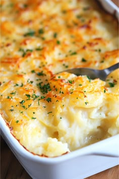 a casserole dish with cheese and parsley on top, ready to be eaten