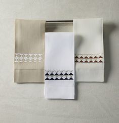 three sheets and two pillow cases on a white surface