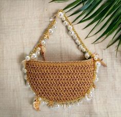 Boho Beach Handbag - Seashell Pearl Handbag - Summer Purse    This stunning boho beach handbag is the perfect summer accessory. Hand crocheted from high quality materials, this purse is both stylish and durable. The natural colored crochet creates a beautiful backdrop for the delicate seashells and pearls that adorn the bag. The gold chain adds a touch of elegance, making this purse perfect for a day at the beach or a night out on the town. Summer Beach Bags Made Of Shell, Beige Pouch Shoulder Bag For Beach, Summer Beach Pouch Shoulder Bag, Bohemian Handheld Bag For Beach Season, Bohemian Handheld Shoulder Bag For Beach Season, Summer Pouch Shoulder Bag With Pearl Handle, Summer Pearl Handle Pouch Shoulder Bag, Beach Season Shoulder Bag Pouch, Summer Shoulder Bag With Pearl Handle And Pouch Shape