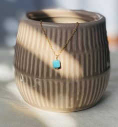 This is a tiny and dainty turquoise pendant necklace with an 18k gold finish over sterling silver. Turquoise represents wisdom, tranquility, protection, good fortune, and hope. Each order comes in a gift box and jewelry pouch, making it the perfect gift. *Please note, natural gemstones have slight variations so each piece will be unique and may vary slightly from what is pictured. This is handmade with love in my Gilbert, Arizona studio. Necklace Details: Finish: 18K Gold Material: Solid 925 Ste