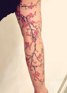 a woman's leg with tattoos on it and flowers painted on the legs,