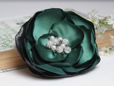 Lovely flower brooch, handmade from layers of delicate satin and organza fabric. Brooch is embellished with little beads. With handy little pin you can attach this lovely corsage brooch to dresses, coats, blouses or whatever you fancy. Effortlessly you can dress up any outfit. Colors: green, gray Dimension: 9cm in diameter and is sewn onto clip. Please note there could be some differences in the color tone between photos and the actual item. Our Zojanka studio specializes in unique handmade acce Green Wedding Brooches, Elegant Green Hair Accessories For Gifts, Elegant Green Hair Accessories For Gift, Elegant Green Brooches With Handmade Flowers, Elegant Green Flower Brooches, Green Flower-shaped Brooches For Weddings, Fabric Brooch, Circle Scarf, Organza Fabric