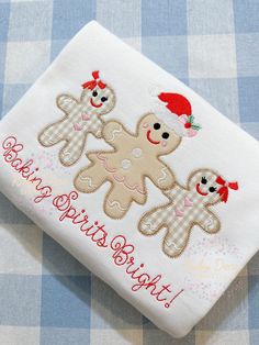 a close up of a piece of cloth on a table with a teddy bear and santa hat