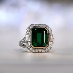 Luxury Heirloom Green Halo Ring, Luxury Green Emerald Ring With Bezel Setting, Timeless Emerald Ring For Anniversary, Gia Certified Green Emerald Art Deco Ring, Luxury Emerald Cut Emerald Ring With Bezel Setting, Luxury Emerald Cut Ring With Bezel Setting, Classic Tsavorite Diamond Ring For Anniversary, Exquisite Green Emerald Platinum Ring, Art Deco Round Cut Emerald Ring