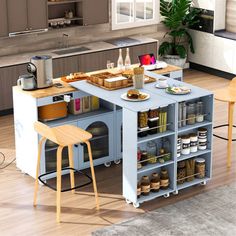 a kitchen island with two stools in front of it and food on the counter