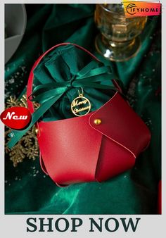 a red purse sitting on top of a green cloth