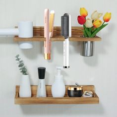 two wooden shelves holding different types of hairbrushes and other bathroom items on them