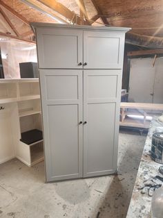 an unfinished room with cabinets and shelves in it