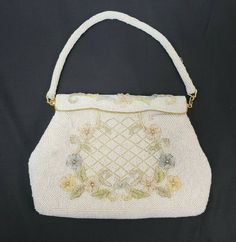 "This is a vintage Debbie Purse/Handbag Made of Opalescent Glass Beads in a flower pattern Made by Debbie in Hong Kong. 1960's estimated Nice Mid Century look! Both the strap and the purse are beaded Has gold tone metal clasps that connect strap to purpose and gold accented opening clasp Purse opens and snaps back into place. Seems to hold by magnets? Measures 9\" wide and approx. 6\" tall (excluding straps) Condition Details: Has minor wear to the outside with a few loose beads. Inside material Vintage Beaded Beige Bags, Vintage Formal Bags For Spring, Vintage Formal Bag For Spring, Formal Vintage Bags For Spring, Retro Beaded Bags For Wedding, Retro Beaded Bag For Wedding, Retro Beaded Wedding Bag, Beaded Handbag, Evening Handbag