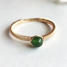 This beautifully simple ring is lovingly handmade with a Jade gemstone and a choice of 14k Gold Filled, 14k Rose Gold Filled or Sterling Silver band. M A T E R I A L S: * Dark Green Jade * 14k Gold Filled, 14k Rose Gold Filled or Sterling Silver S I Z E: * Gemstone - Approximately 4mm All of our jewellery is carefully handmade using good quality materials and handpicked gemstones, with the aim to produce quality pieces that you can love & wear for years to come. J A D E: * Talisman for Aries, Ta Wire Ring Aesthetic, Jade Gemstone Jewelry, Simple Wire Rings, Wire Wrap Rings, Wired Ring, Diy Wire Jewelry Rings, Wire Jewelry Rings, Diy Jewelry Rings, Diy Ring