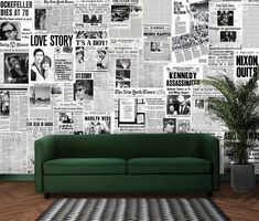 a green couch sitting in front of a wall covered with newspaper