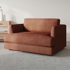 a brown chair sitting on top of a carpeted floor