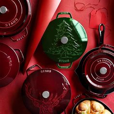 red and green christmas themed cooking utensils on a red table with other items