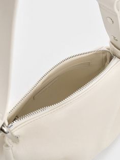 This product is made with at least 20% sustainable materials by weight. CHARLES & KEITH uses recycled, degradable, organic, and water-based materials in our eco-conscious collection. Balancing style with functionality, the Lumen crossbody bag will be a nifty addition to your wardrobe. While the exterior is kept minimalist, the padded texture and tasteful folds add subtle visual interest. With its clean cream finish, it will brighten up your outfits with a charming tactility. Equipped with an adjustable strap, you can opt to sling it on the shoulder or across the body. Cute Shoulder Bag, White Purse, Pretty Bags, Charles Keith, Eco Conscious, Sustainable Materials, Kids Gifts, Bag Straps, Sales Gifts