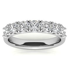 a wedding ring with five stones on the side and four rows of diamonds in the middle