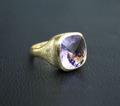 ♦♦ Beautiful handcrafted ring ◘Stone Information: Genuine Amethyst - Color: Purple Cut: Briolette Cushion Size: 15 mm ◘ Metal: 925 Sterling Silver ◘ Band: 4.5 mm textured ◘ Setting: Open back bezel setting ◘ Finish: High polish (shiny) ◘ Nickel free ◘ Anti tarnish ◘ Vermeil Gold ◘ Handmade band: 14 gauge solid sterling wire This ring is adorably rustic, easy to wear, & stackable! ◘Please Note - The Ring in the Picture can be available or Sold out. Every Ring is Made of a Unique Gemstone. The Timeless Amethyst Ring As A Gift, Timeless Amethyst Gemstone Rings, Elegant Formal Amethyst Ring With Large Stone, Formal Amethyst Jewelry With Large Stone, Elegant Large Stone Amethyst Ring, Formal Large Stone Amethyst Jewelry, Elegant Amethyst Signet Ring Hallmarked, Elegant Amethyst Hallmarked Signet Ring, Formal Amethyst Rings With Vs Clarity