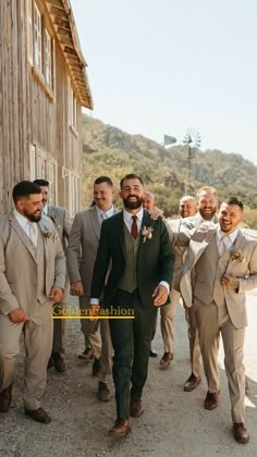 a group of men standing next to each other in front of a wooden building wearing suits and ties