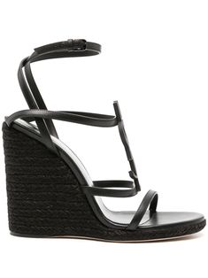 black calf leather signature Cassandre tonal logo plaque multi-way strap design open toe buckle-fastening ankle strap branded footbed 115mm braided raffia wedge heel Brown Wedge Sandals, Wedge Espadrilles, Black Espadrilles, Leather Espadrilles, Black Wedge Sandals, Saint Laurent Shoes, Buffalo Leather, Dolce E Gabbana, Black Wedges