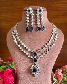 Charm and shine in this beautiful American diamond necklace set that features high quality AAA zircon necklace and earrjngs! It's sure to bring compliments your way with its unique design and a stunning variety of colors.  The necklace comes with an adjustable chain so that you can customise it as per the requirement of the outfit. Available in sapphire blue and yellow. Bridal Outfit Indian, Outfit Indian, Necklace Set With Earrings, American Diamond Necklaces, Zircon Necklace, Bridal Outfit, Diamond Necklace Set, Jewelry Bridal, Wedding Jewellery Necklace