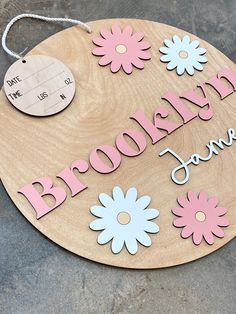 a wooden sign that says brooklyn jones with flowers on it