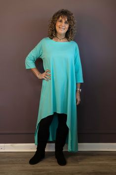 Take your style up a notch with the Hi-Lo Tunic Dress. This versatile dress features a daring high low hemline and 3/4 length sleeves for an edgy look. Wear it as a dress or a tunic with leggings or jeans - the choice is yours! One Size, recommends for sizes 2-14 Armpit to Armpit: 22 1/2", Side Seam Length: 37", Sleeve Length: 15 1/2", Bicep: 14", Length in Front 32 1/4", Length in Back 45" 95% Cotton, 5% Elastane Machine Wash Cold, Tumble Dry Low Green 3/4 Sleeve Midi Dress For Summer, Green 3/4 Sleeve Summer Midi Dress, Green 3/4 Length Dress For Spring, Green Summer Midi Dress With 3/4 Sleeves, Green Half Sleeve Dress For Fall, Green Half Sleeve Fall Dresses, Green Stretch Dress With Asymmetrical Hem, Fitted Green Tunic For Spring, Green High-low Hem Midi Dress For Summer