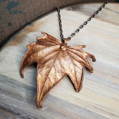 Real Sycamore leaf is copper electroformed and has an added patina. The pendant is then finished with a coating of clear enamel spray to protect the color and also to prevent the copper from discoloring skin from oxidation. *24 inch chain with a lobster clasp is included. Chain is made of iron with a dark silver color plating.  *You will receive this exact copper leaf pendant.  CREATING PROCESS  Handmade and created from a real leaf that I have found outside or from one of my plants. Each piece goes through the process drying, clear coat, conductive paint, and then electroformed; which is basically copper plating organic or non metal material. Then I'll give it a few finishing touches. Once completed I cover it with a protective clear coating to stop further oxidation. Hand Cast Copper Pendant Necklace, Hand Cast Copper Pendant Necklaces, Bronze Patina Copper Necklace, Bronze Copper Necklace With Patina, Bronze Copper Leaf-shaped Jewelry, Electroformed Leaf-shaped Copper Jewelry, Sycamore Leaf, Copper Plating, Real Leaf