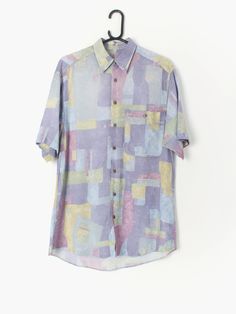 90s Vintage abstract shirt lilac and pastel green, yellow and blue prints with short sleeves Our recommended size: Medium Label Says: 37 / 38 Condition: Very good Material: Feels like viscose Measurements in inches: Pit to pit: 21 Shoulders: 19 Front length: 32 Back length: 33 Sleeve length: 10.5 We've provided garment measurements below and suggest you compare these to a similar garment you own to determine a good fit. Measurements are taken flat and doubled for waist and hip. Information on ho Fitted Multicolor Print Short Sleeve Shirt, Purple Printed Shirt With Short Sleeves, Multicolor Floral Print Short Sleeve Shirt, Casual Tops With Abstract Pattern And Short Sleeve, Patterned Short Sleeve Shirt For Spring, Summer Tops With Multicolor Abstract Print, Summer Top With Multicolor Abstract Print, Summer Multicolor Print Top With Abstract Pattern, Multicolor Print Top With Abstract Pattern For Summer