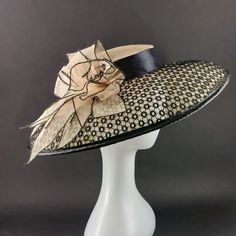 "Stunning extra wide brim Audrey Hebburn hat for Kentucky derby or Royal Ascot, made of high quality cream sinamey. The crown is 2\" (5 cm) high and it stays on the top of your head. It is secured with elastic that goes under your hair. The brim is covered with an astonishing black cotton lace and the hat is decorated with natural color sinamey flower. The wide from 5.5\" to 6\" (14 to 15 cm) brim make it really special and suits almost all face types. The hat is hand blocked on a wooden block and hand stitched to perfection at Irina Sardareva millinery atelier. It is great to wear on Derby races, Royal Ascot, Cocktail parties, Weddings, Tea parties, etc. This hat is available is with low crown and fitting is secured by elastic. It fits all head sizes. We deliver by Priority mail service. Audrey Hepburn Hat, Black Birdcage Veils, Goddess Wear, Victorian Outfit, Elegant Hat, Big Hats, Lace Hat, Dressy Hats, Classy Hats