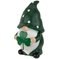 a green and white gnome figurine holding a shamrock