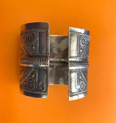 "Presenting a wonderful vintage, solid silver cuff BRACELET from Tunisia. The bracelet measures over 2 1/2\" (6,45 cm) wide and its inner diameter is 2 3/4\" (7,0 cm), though it is FULLY ADJUSTABLE. The bracelet features wonderfully textured floral and geometric designs. It has Tunisian and Libyan hallmarks for 800 silver. This piece is also an excellent size for a man's wrist." Bohemian Oxidized Silver Cuff Bracelet, Traditional Antique Silver Cuff Bracelet With Oxidized Finish, Antique Silver Adjustable Bohemian Cuff Bracelet, Bohemian Silver Cuff Bracelet With Inlay, Luxury Vintage Cuff Bracelet With Oxidized Finish, Wide Cuff, African Jewelry, Silver Cuff Bracelet, Tunisia