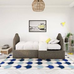 a bed sitting on top of a rug in a bedroom