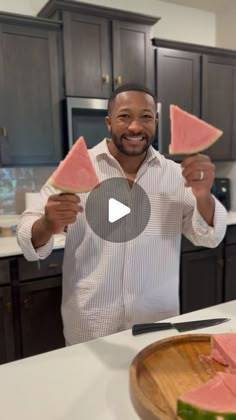 a man holding up slices of watermelon in front of his face and smiling