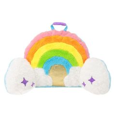 a stuffed animal toy with a rainbow on it's back and two clouds in the middle