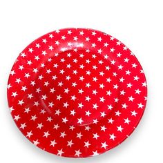 a red plate with white stars on the rim and bottom, in front of a white background