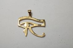 "Egyptian carving Handmade Blue Eye Of Horus 18K Yellow Gold Pendant 5 Gr Weight Approximate : 5 Gr Height : 1.2\" = 32 mm Width : 1.2\" = 31 mm ✔ IT IS Tested & SIGNED WITH THE EGYPTIAN Gold Government HALLMARK FOR 18K GOLD to Ensure Authenticity. ✔ Lovely gift idea ABSOLUTELY GORGEOUS, LOOKS FABULOUS ON. ✔ 100% Egyptian handmade. ✔ Condition: A brand-new, exactly as on the photos. ★ GIFTS ✔ All items are packaged in a paper jewelry gift box, ready for gifting. ✔ If you are sending a gift d Symbolic Pendant With Diamond Eyes, Symbolic Yellow Gold Jewelry With Diamond Eyes, Symbolic Eye-shaped Jewelry Gift, Yellow Gold Evil Eye Jewelry For Anniversary, Gold Amulet Jewelry With Diamond Eyes, Handmade Ankh Jewelry In Yellow Gold, Gold Plated Evil Eye Symbolic Jewelry, Symbolic Gold Plated Evil Eye Jewelry, Handmade Yellow Gold Ankh Jewelry