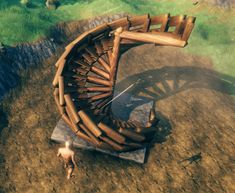 an aerial view of a wooden structure in the middle of a field with two people standing near it