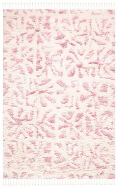 a pink and white rug with an intricate design on the bottom, it is very soft