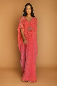 Pink kaftan tunic with all-over Leheriya print, embroidered V-neckline and asymmetric hem. Comes with inner.
Component: 2
Printed, Embroidered
Neckline: V-Neck
Sleeve Length: Three Quarter
Fabric: Georgette
Color: Pink
Embroidery at the sleeves and waist
Gathers at the back
Asymmetric hem
Note: Belt worn by the model is not for sale - Aza Fashions Kaftan Pattern, Kaftan For Women, Kaftan Designs, Royalty Aesthetic, Dream Wedding Ideas Dresses, Embroidered Neckline, Fashion App, Kaftan Dress, Designer Gowns