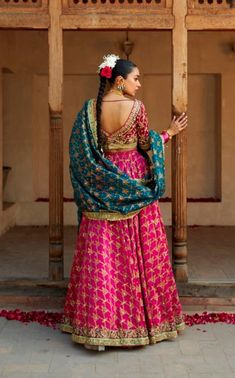 The wedding Bridal Lehenga Choli and Blue Dupatta Dress is a breathtaking masterpiece adorned with gota, threads, sequins, zardosi, and gold work. Premium quality fabric and lavish designs make this Lehenga Dress an epitome of beauty and grace. Bridal Choli: The choli in magenta color is beautifully adorned with goldwork and hand-crafted gota and zardosi work. Goldwork and shimmering sequins give a traditional touch to this perfectly stitched choli with half sleeves. Embroidery and threads give Bridal Choli, Dupatta Dress, Lehenga Dress, Blue Dupatta, Bridal Dupatta, Zardosi Work, Sleeves Embroidery, Raw Silk Fabric, Magenta Color