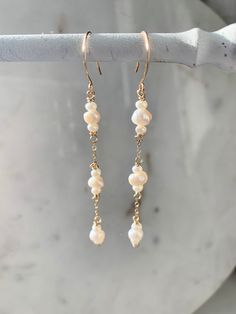 These minimalist freshwater Pearl drop earrings will be the perfect compliment to any wedding dress for a bride to be, or jewelry gifts to bridesmaids. The classic style of these earrings will make them a wardrobe staple long after the big day, too!  Made with 14/20k gold filled wire, delicate chain and genuine organically shaped freshwater Pearl beads, these light-weight but sturdy dangle earrings measure about 2.5 inches in length.  Available in Sterling Silver upon request - note in personali Earrings For Bride, Real Pearl Earrings, Earrings Real, Delicate Wedding, Beads Craft Jewelry, Freshwater Pearl Drop Earrings, June Birthstone Jewelry, Jewelry Pearl, June Birthstone