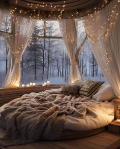 a bed in a room with lights on the ceiling and curtains hanging from the windows