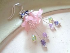 Alluring dangle flower earrings in Sterling silver only, with powdery pink or teal bell flowers in Lucite, and with 3 stamens dangling down from within in glittering beauty! These ANNALEAS FINEST earrings are made with Swarovski® crystals and are the safest solution for women with sensitive ears!  So romantic for elf and fairy dresses, for a wedding and many more occassions.  I handcraft the earwires and polish the ends round for best compatibility. Please come to my shop here: https://www.etsy. Whimsical Pink Earrings With Flower Charm, Whimsical Pink Flower Earrings For Pierced Ears, Whimsical Pink Flower Charm Earrings, Pink Whimsical Flower Earrings With Flower Charm, Pink Whimsical Flower Earrings For Pierced Ears, Pink Whimsical Flower Charm Earrings, Whimsical Pink Dangle Flower Earrings, Whimsical Dangle Jewelry With Flower Charm, Pink Flower Charm Dangle Jewelry