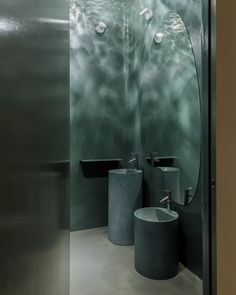 a bathroom with two sinks and mirrors in it